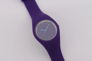 Detailed view of purple silicone strap and minimalist round Geneva quartz watch face