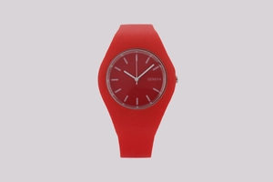 Macro detail of red silicone strap and minimalist Geneva dial with white index markers