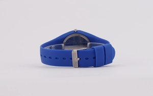 Detail view of the sky blue silicone watch strap and polished silver buckle closure