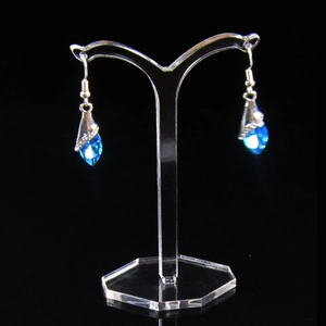 Blue teardrop crystal earrings on a clear T-shaped acrylic jewelry display stand