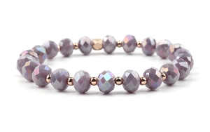 Detailed view of faceted amethyst beads with rose gold accents on an elastic bracelet