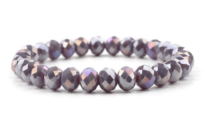 Macro shot of faceted grey-purple crystal beads with metallic luster on white background