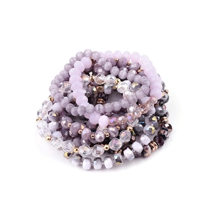 Detail view of Bohemian multi-layer beaded bracelets with natural amethyst and crystals