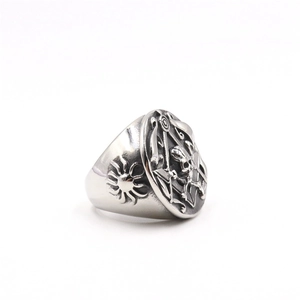 Macro detail of vintage stainless steel masonic skull ring with sun pattern engraving