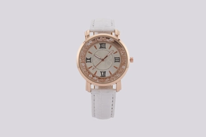 Detailed close-up of a rose gold quartz watch with a white crocodile leather strap