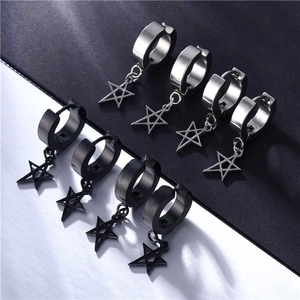 Detail of black and silver stainless steel hoop earrings with star pendants on split background