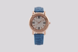 Detail of luxury rose gold watch with blue leather strap and crystal-set Roman dial