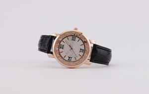 Detailed macro view of rose gold bezel with sparkling crystals and Roman numeral dial