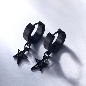 Macro shot of black titanium steel star drop earrings on a brushed metal background