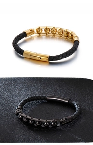 Close-up of woven leather bracelets with metallic beads in black and gold finishes