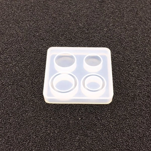 Macro detail of square silicone mold with four circular cavities for resin casting