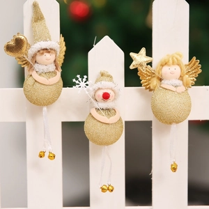 Close-up of golden Christmas dolls with glitter ornaments, bells and white fur details