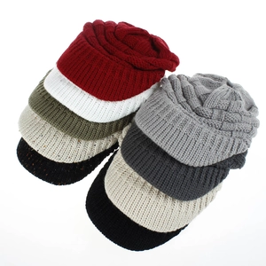 Detailed grid of knitted ponytail baseball caps in nine various colors and cable patterns