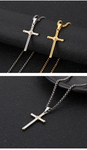 Detailed view of punk style stainless steel cross pendant in silver and gold dual-tone finish