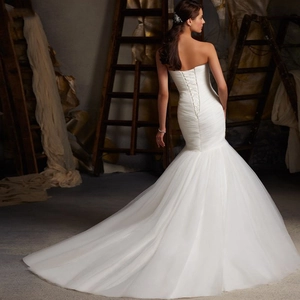 Elegant white strapless mermaid evening dress with a lace-up back and long train tail