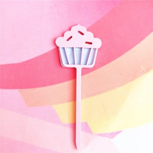 Pink cupcake cake topper detail close up shot, cute acrylic baking dessert decoration prop.