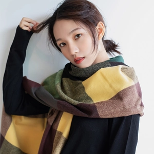 Thick winter scarf with oversized green and yellow plaid pattern in soft cashmere style