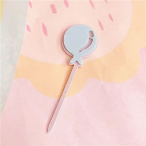Close up detail shot of the cute pink and blue acrylic cake topper showing fine craftsmanship.