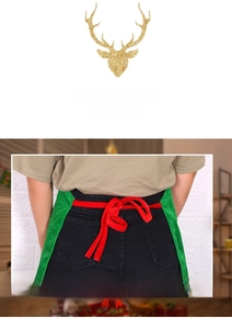 Close-up of green velvet Christmas apron with red ribbon tie at the back waist detail