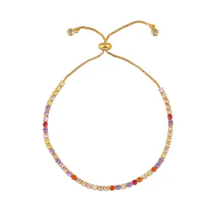 Detail of adjustable gold tennis bracelet featuring colorful cubic zirconia eye charms