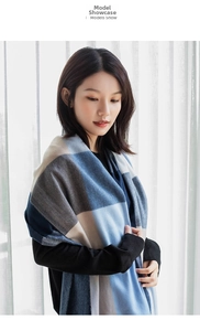 Detailed view of soft cashmere-like scarf with large sky blue and navy check pattern