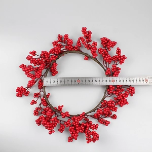 Close-up of red berry Christmas wreath showing an inner diameter measurement of 18cm