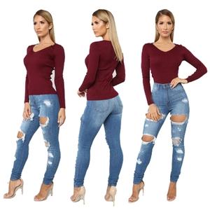 Women's burgundy slim long sleeve knit top and light blue ripped high waist skinny jeans