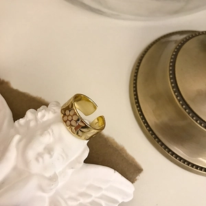 Close-up of S925 hallmark on a gold-plated flower ring with colorful resin petals