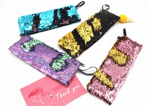 Four sequin mermaid pencil cases in blue, black, purple, and pink with a thank you card