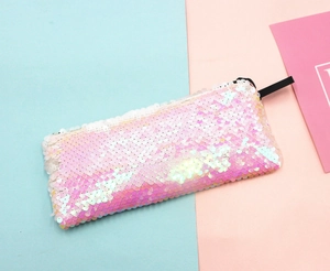 Detail of pink and white gradient mermaid sequins on a rectangular makeup pouch