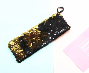 Detail of reversible gold and black sequins on a rectangular pencil case storage bag
