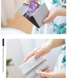 Detail of grey PU leather card holder showing leaf pendant and accordion slots
