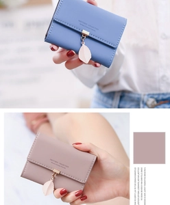 Detail of blue and pink PU leather card holders with unique metal leaf pendants