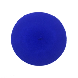 Top down view of a classic royal blue wool felt beret hat with signature top stem detail