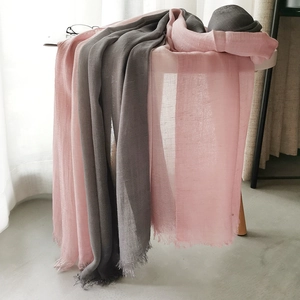 Detail of pink and dark grey gradient linen scarf with fringed edges in natural light