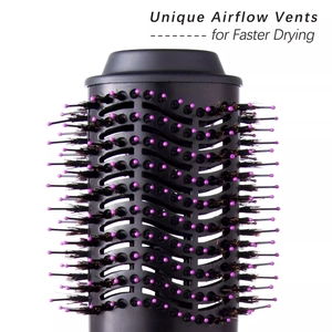 Detail of unique airflow vents on hot air brush with pink-tipped bristles for fast drying