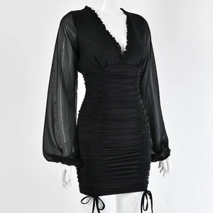 Detail of black V-neck mini dress featuring sheer mesh long sleeves and ruched texture