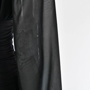 Detail of sheer mesh sleeves and ruched texture on this sexy black deep V mini dress