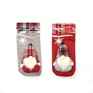 Christmas gnome wine bottle covers in red and grey fabric with plush beard and snowflakes