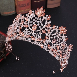 Detail of Baroque bridal crown with champagne crystals and rose gold floral swan motifs