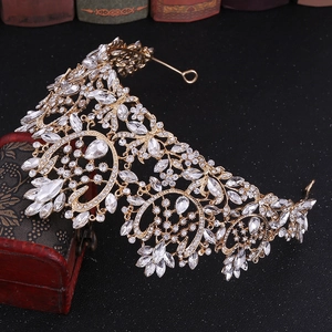Detailed view of luxury baroque bridal crown with crystals on vintage wooden box