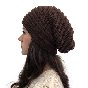 Detailed side view of women's dark brown cable knit slouchy beanie for winter warmth