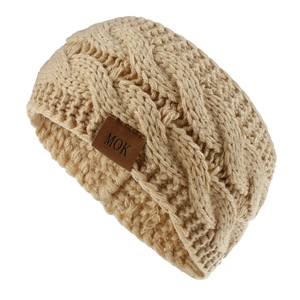 Close-up of thick cable knit texture and brown leather brand tag on khaki ear warmer