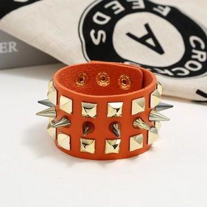 Orange punk leather cuff bracelet with three rows of gold spikes and metal studs