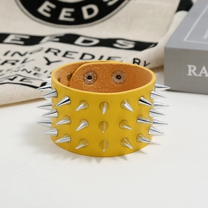 Punk yellow leather bracelet with three rows of silver cone spikes and snap closure