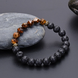 Faceted tiger eye and black lava stone beaded bracelet on a natural stone base