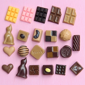 Assorted miniature resin chocolates in various shapes and colors for DIY craft decoration