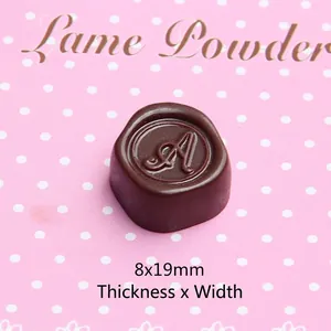 Macro view of a 19mm brown resin chocolate charm with an elegant engraved letter A