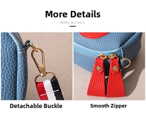 Close-up of the metal detachable hooks and red leather zippers on a blue crossbody bag