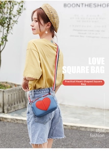 Litchi texture mini bag with red heart patch and striped webbing strap on female model